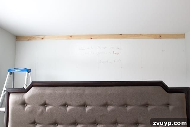 How to Build Your Own Planked Board and Batten Accent Wall Part 1 4 Bible verse written on wall before DIY planked board and batten installation