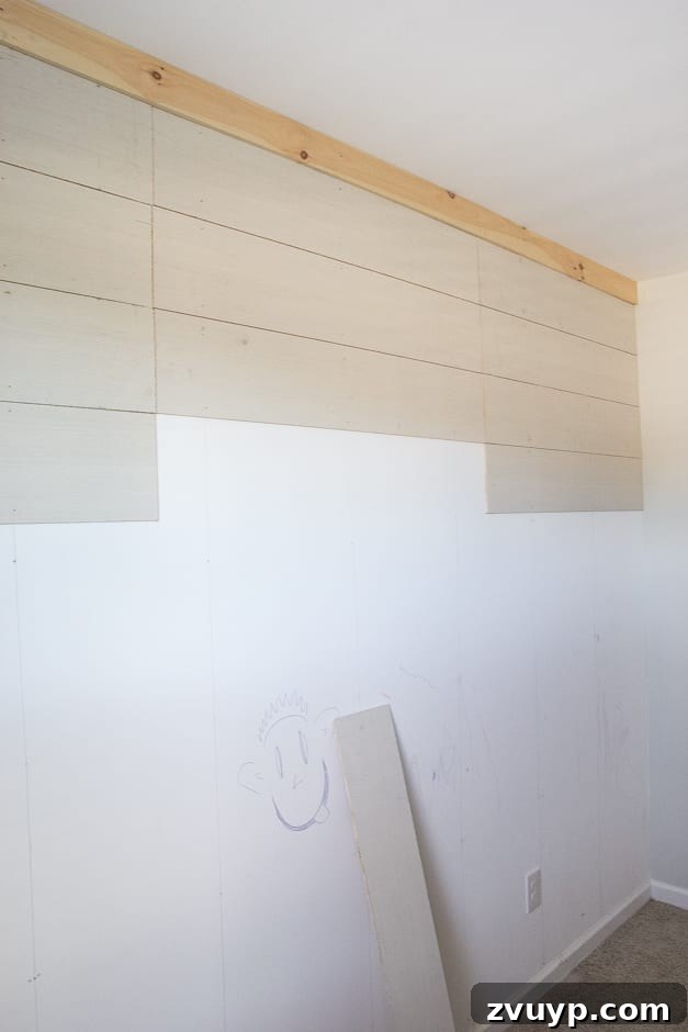 How to Build Your Own Planked Board and Batten Accent Wall Part 1 5 Installing horizontal plywood planks for DIY accent wall