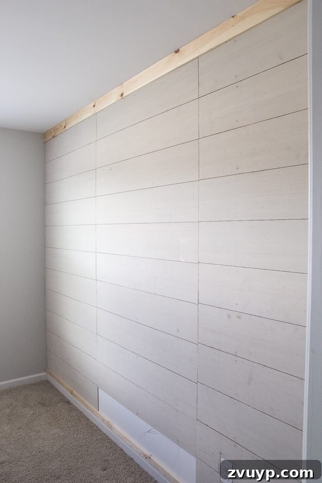 How to Build Your Own Planked Board and Batten Accent Wall Part 1 6 Bottom horizontal rail installation for DIY planked board and batten