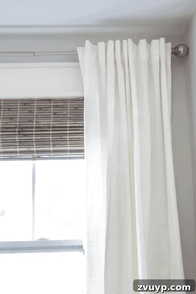 From Basic to Brilliant: 3 Windows Upgrade Secrets 4 Master bedroom window after makeover with layered curtains and Roman shades