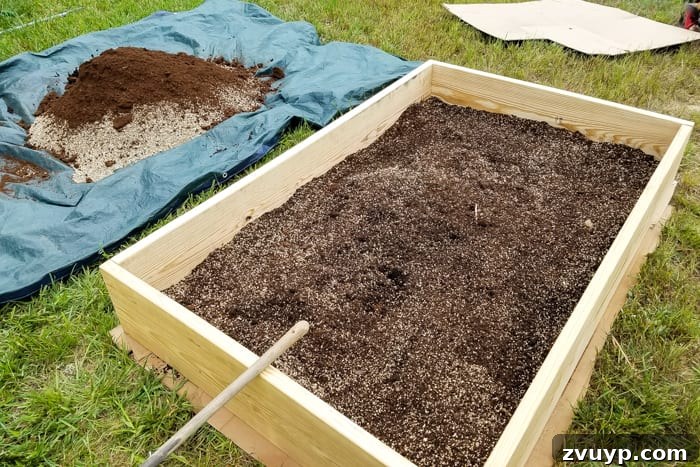 Bountiful Beds: Master High-Yield Raised Bed Vegetable Gardening 11 mixing soil, peat moss, vermiculite, and compost together for building a raised bed vegetable garden frame