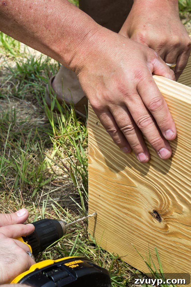 Bountiful Beds: Master High-Yield Raised Bed Vegetable Gardening 9 screwing boards together for building a raised bed vegetable garden frame