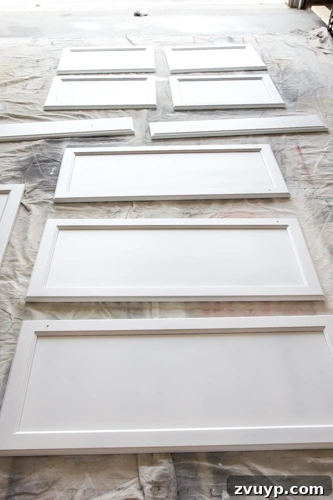 Flawless Cabinets: Paint Your Kitchen Like a Seasoned Pro 10 Spraying the front of a kitchen cabinet door with Benjamin Moore Advance paint for a smooth, durable finish. Step-by-step DIY painting guide.