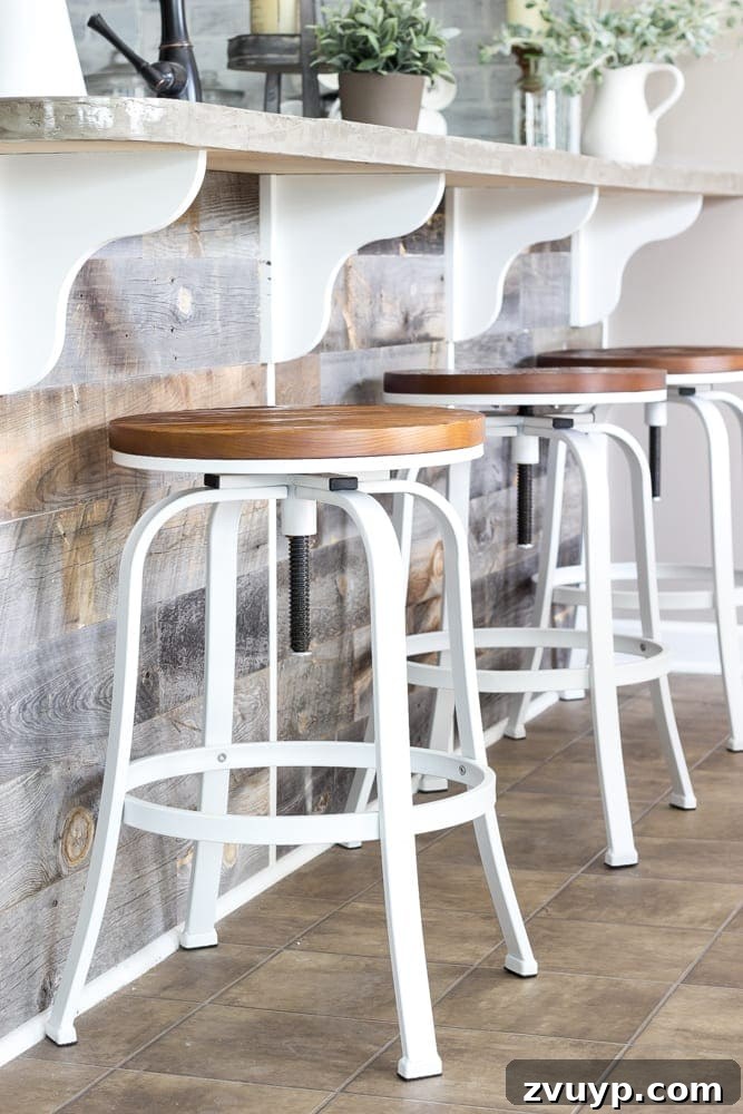 Our Stunning Modern Farmhouse Kitchen Transformation 14 The reclaimed wood bar area with Olivia enjoying lunch, highlighting the practical and stylish Stikwood installation.
