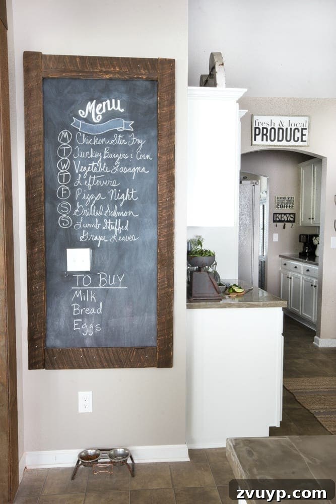 Our Stunning Modern Farmhouse Kitchen Transformation 17 A close-up of the framed chalkboard made from reclaimed wood, showcasing its rustic charm and practical use for family organization.