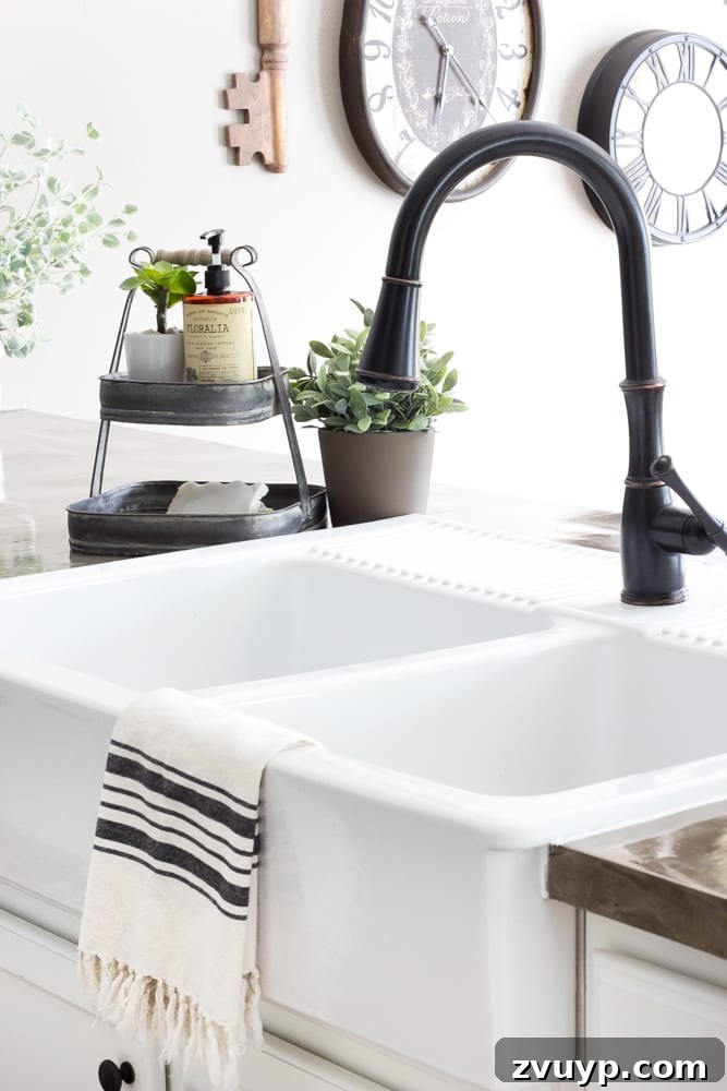 Our Stunning Modern Farmhouse Kitchen Transformation 22 A practical tiered tray neatly organizing dish sponges and soaps beside the sink, ensuring a tidy and functional workspace.