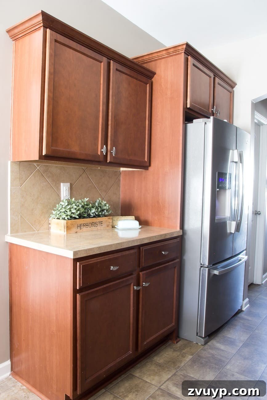Our Stunning Modern Farmhouse Kitchen Transformation 7 The uninspired beige Formica countertops and tiled backsplash from the original kitchen, awaiting a dramatic DIY transformation.