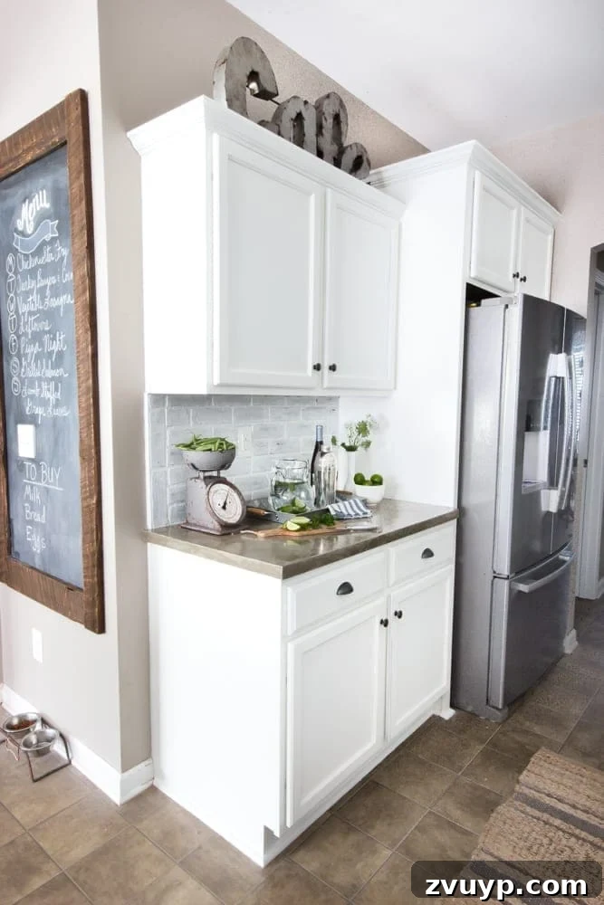Our Stunning Modern Farmhouse Kitchen Transformation 8 The breathtaking new concrete countertops and whitewashed faux brick backsplash, a testament to budget-friendly DIY ingenuity and style.