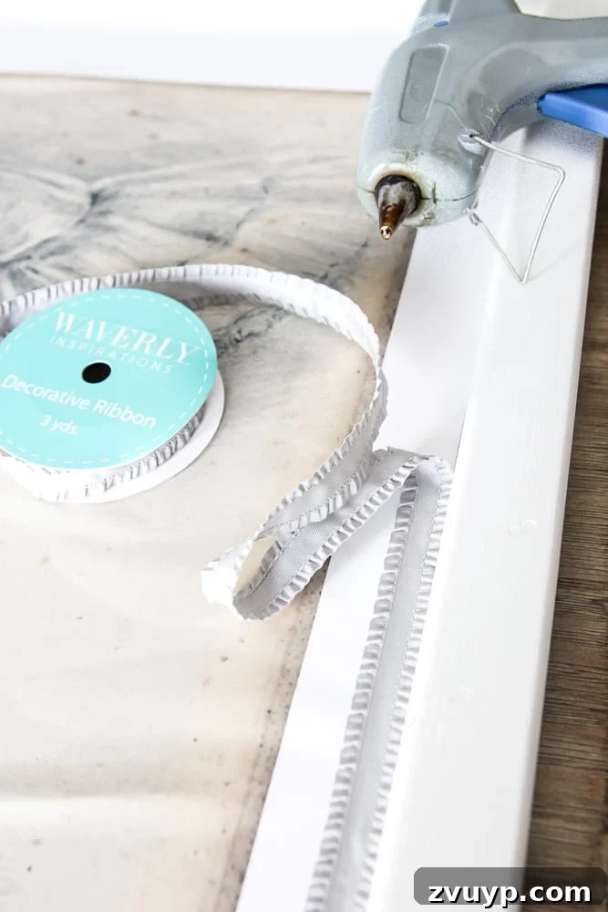 Mirror Frames Reborn as Photo Displays 9 Finishing touch: Adding decorative gray ribbon around the art print on the repurposed frame