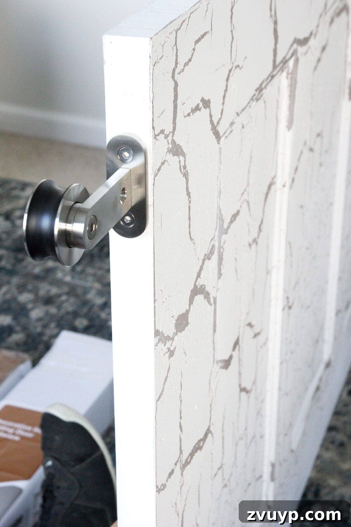 DIY Sliding Barn Door Installation Guide 11 Attaching the rollers to the top of the hollow core doors using a template for accurate placement.