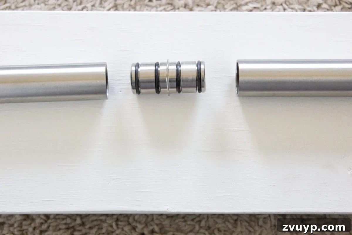 DIY Sliding Barn Door Installation Guide 8 Connecting two barn door tracks with a special adaptor to create one long, seamless track.