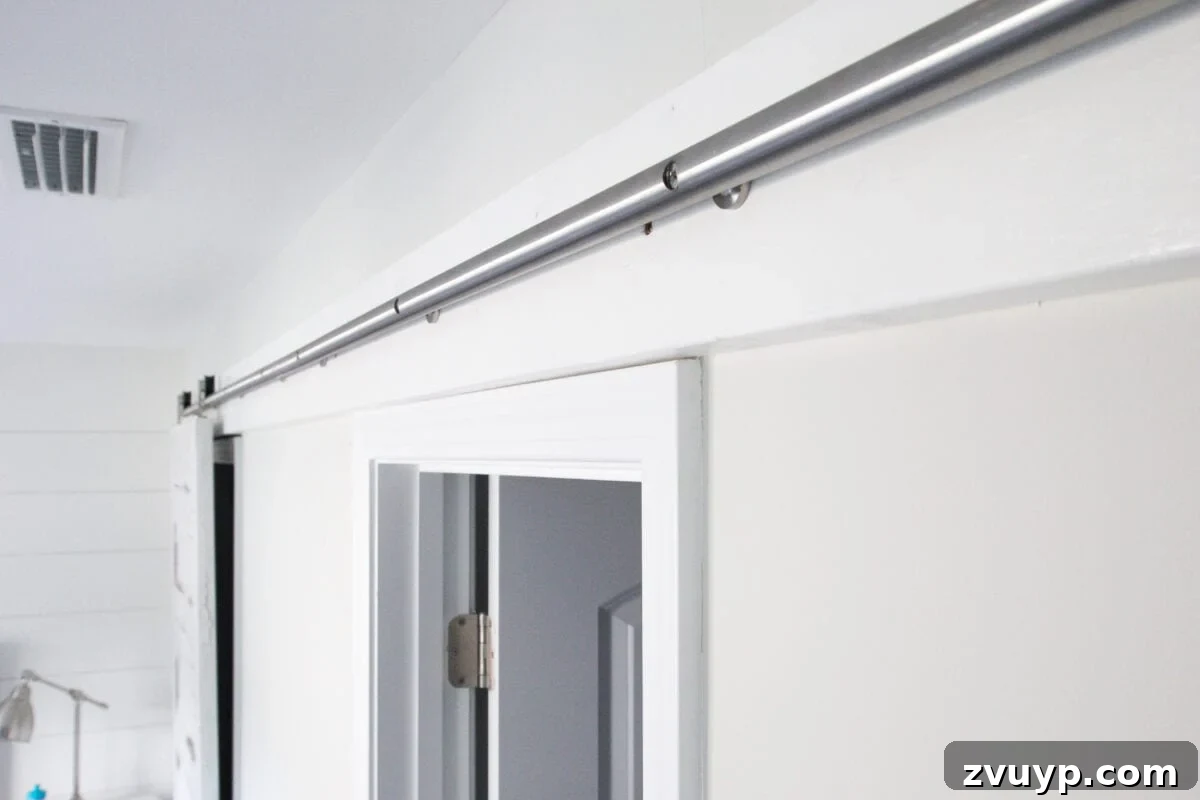 DIY Sliding Barn Door Installation Guide 10 The barn door track is fully installed and ready for doors to be hung.