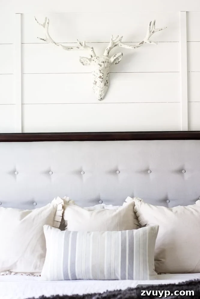 Unveiling Our Rustic Modern Sanctuary: Master Bedroom Decor & Shopping Guide 14 Faux stag head ('Pat the Deer') above the bed, a personal touch in the rustic modern bedroom