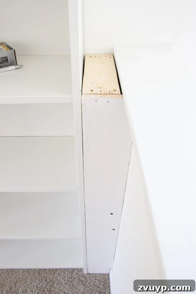 Using 1x6 boards and 2x4 boards to build a box between a bookcase and a wall to make built in