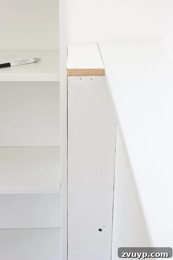 Filling a gap with a constructed box between a bookcase and a wall to make a built in shelf