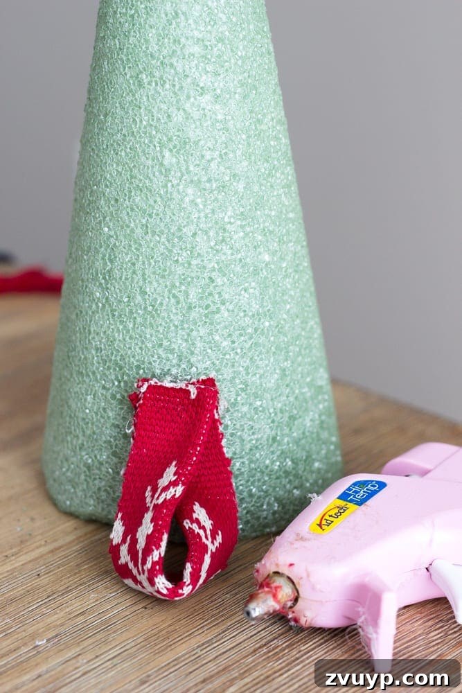 Cozy Knit Mini Christmas Trees 8 DIY Nordic Sweater Mini Christmas Trees | blesserhouse.com - How to make Nordic sweater mini Christmas trees using just florist foam, ribbon, and hot glue for cute decor accents on tabletops and mantels.