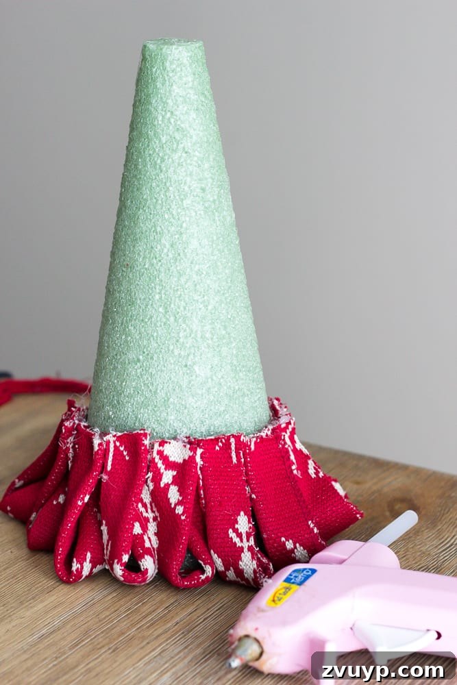Cozy Knit Mini Christmas Trees 9 DIY Nordic Sweater Mini Christmas Trees | blesserhouse.com - How to make Nordic sweater mini Christmas trees using just florist foam, ribbon, and hot glue for cute decor accents on tabletops and mantels.