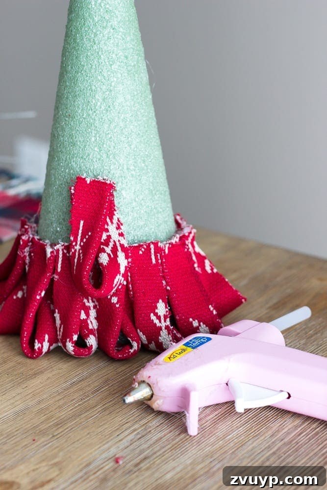 Cozy Knit Mini Christmas Trees 10 DIY Nordic Sweater Mini Christmas Trees | blesserhouse.com - How to make Nordic sweater mini Christmas trees using just florist foam, ribbon, and hot glue for cute decor accents on tabletops and mantels.