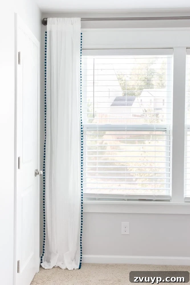 One Room Challenge Week 6 Our Eclectic Farmhouse Playroom Is Here 22 DIY pom pom curtains made from IKEA sheers - budget-friendly window treatment.