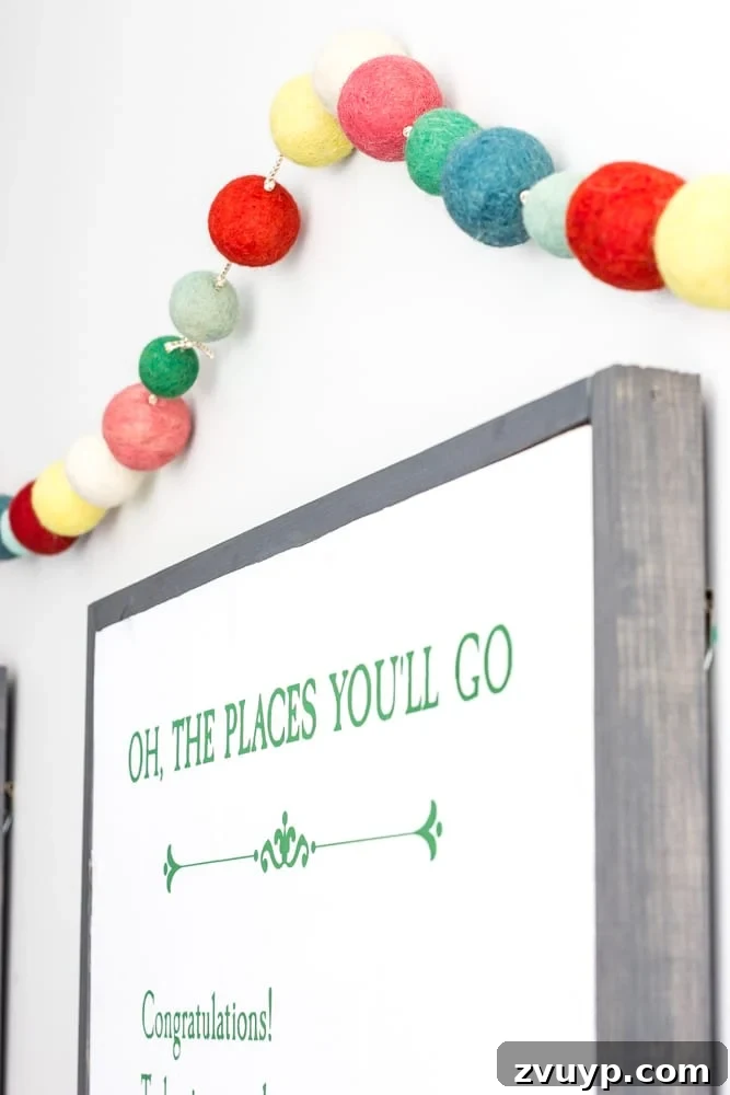 One Room Challenge Week 6 Our Eclectic Farmhouse Playroom Is Here 30 Felted pom pom garland adding whimsy to the playroom.