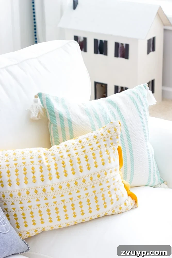 One Room Challenge Week 6 Our Eclectic Farmhouse Playroom Is Here 31 Colorful throw pillows on the sofa - defining the color scheme.