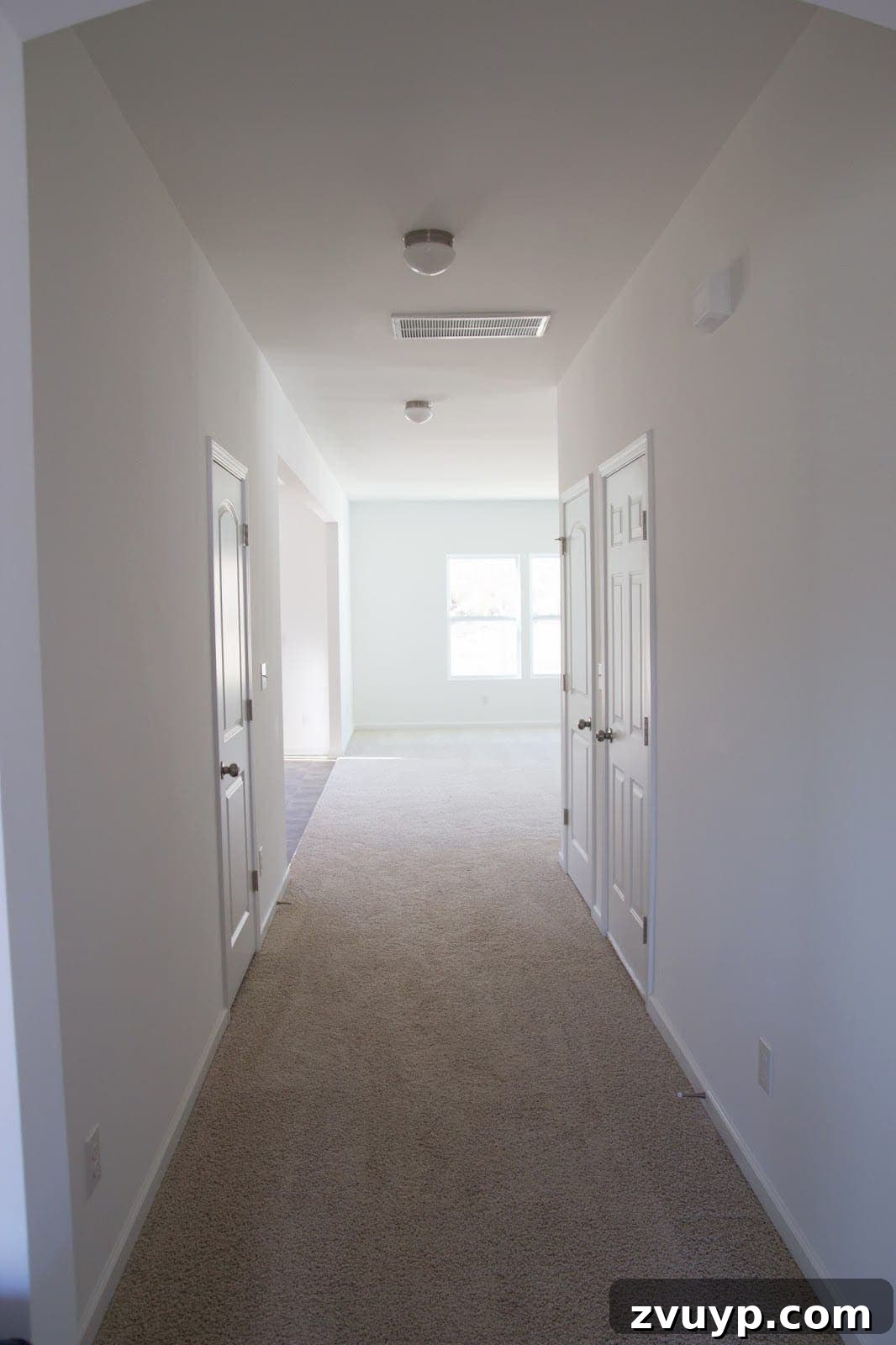 Three Years, One Home: The Transformation Tour 5 Hallway before makeover: a narrow and plain space in a suburban tract house.