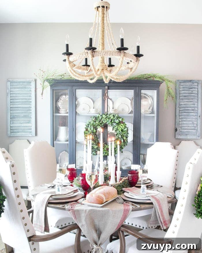 Three Years, One Home: The Transformation Tour 8 Dining room after makeover: elegant and budget-friendly with DIY rope chandelier, refinished china cabinet and dining table, and reupholstered chairs, decorated for Christmas.