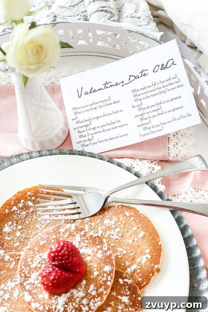 Overhead view of the styled shabby chic breakfast tray with food, Q&A postcards, and floral accents for Valentine's Day.