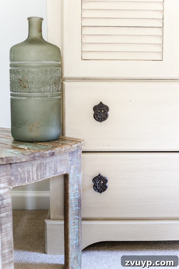 Distressed Shutter Armoire Transformation 4 Close-up of the new cast iron hardware on the creamy, faux antique armoire, finished with Fusion Mineral Paint and Espresso wax.