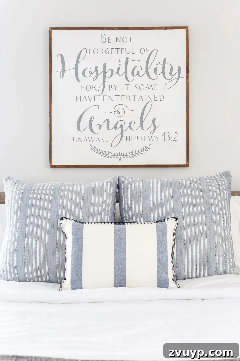 From Weathered to Wonderful A Painted Bed Revival 11 A lovely hospitality scripture sign from Salted Words on Etsy, adding a thoughtful and welcoming touch to the guest bedroom decor.