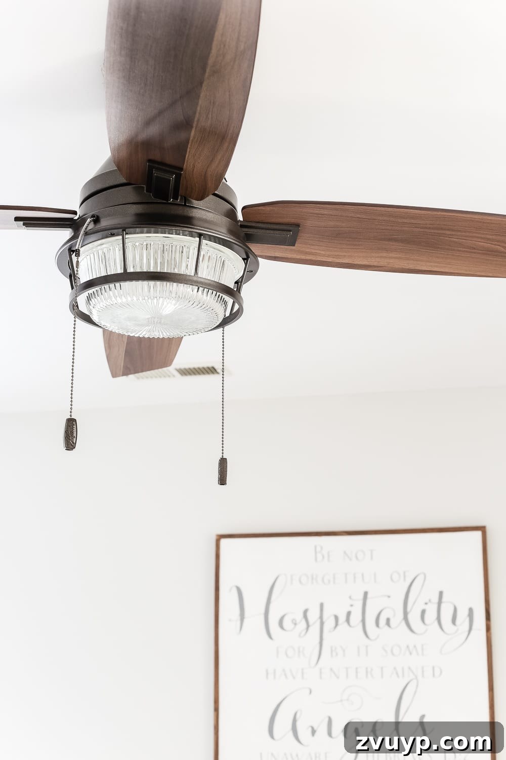 From Weathered to Wonderful A Painted Bed Revival 12 Hunter Fan Co. ceiling fan with vintage-look wood blades, perfectly complementing the rustic aesthetic of the guest bedroom.