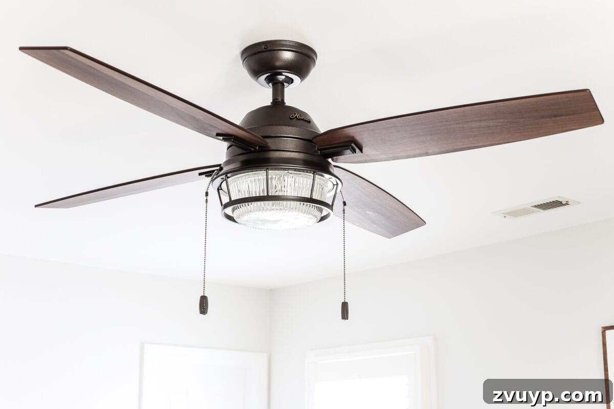 From Weathered to Wonderful A Painted Bed Revival 13 Overall view of the guest bedroom, featuring the new weathered wood bed and Hunter ceiling fan, showing the cohesive design.