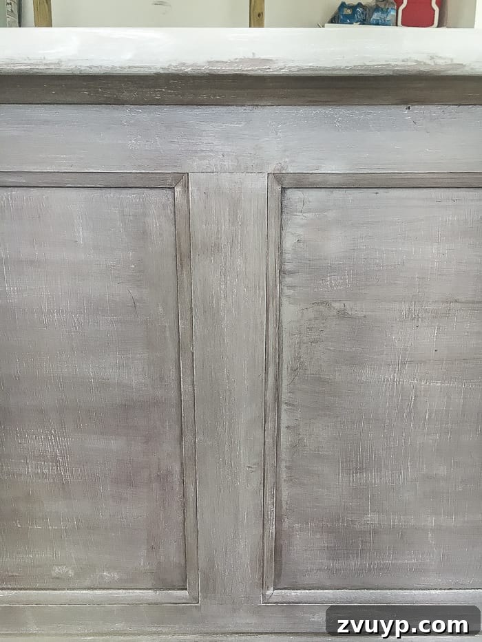 From Weathered to Wonderful A Painted Bed Revival 7 Applying Espresso wax to the weathered wood painted bed, demonstrating how to create an aged patina and add depth to the finish.