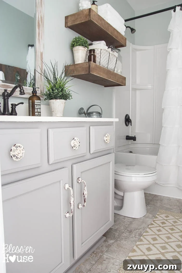 Transform Your Builder Home with Farmhouse Style 12 A newly painted white bathroom vanity with stylish new hardware and a farmhouse-inspired faucet, showcasing a budget-friendly cabinet makeover.