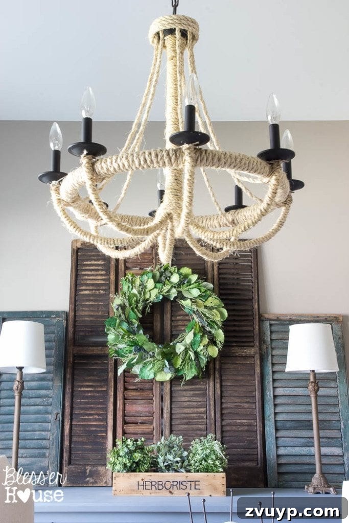 Transform Your Builder Home with Farmhouse Style 13 A stunning DIY rope chandelier hanging over a dining table, illustrating how creative lighting can add farmhouse character.