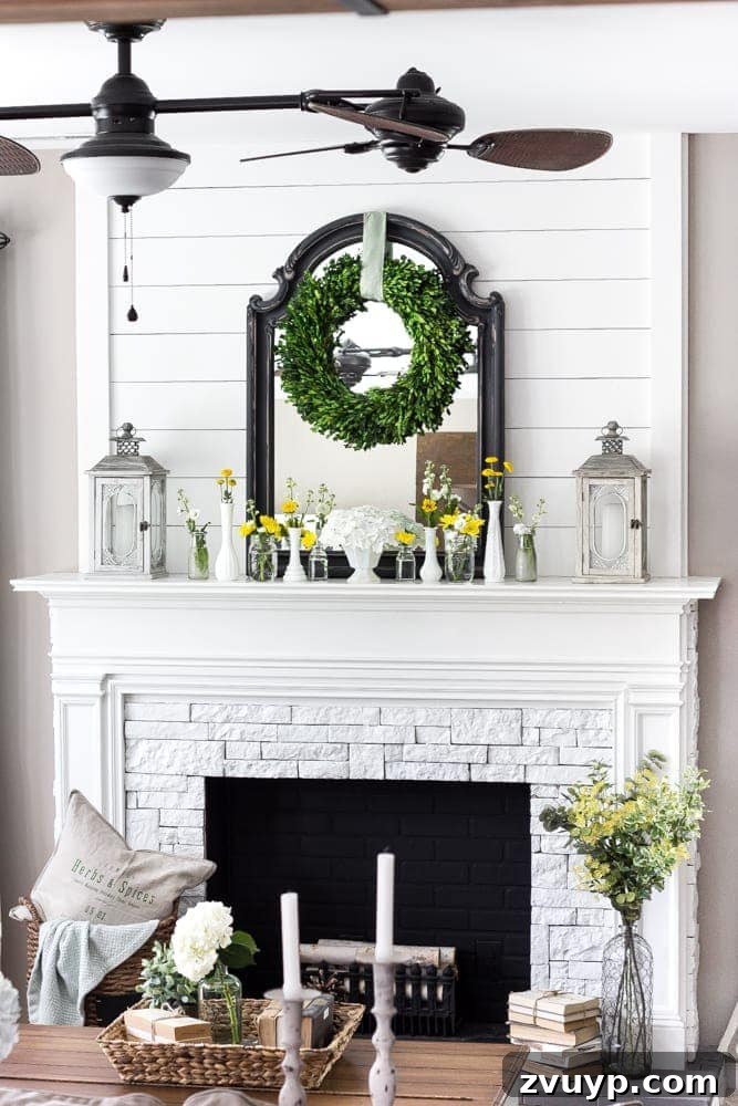 Transform Your Builder Home with Farmhouse Style 16 A DIY faux fireplace with a white mantel and exposed brick wallpaper, decorated with farmhouse elements, creating a cozy living room focal point.
