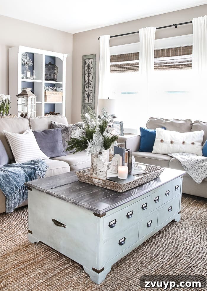 Transform Your Builder Home with Farmhouse Style 17 A large neutral-toned textured area rug anchoring a farmhouse living room with white sofas, distressed coffee table, and cozy decor.