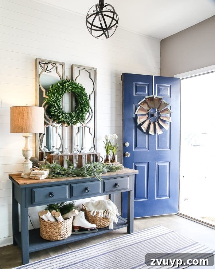 Transform Your Builder Home with Farmhouse Style 18 A vintage metal windmill artfully repurposed as wall decor in a farmhouse entryway with a rustic bench and other antique elements.