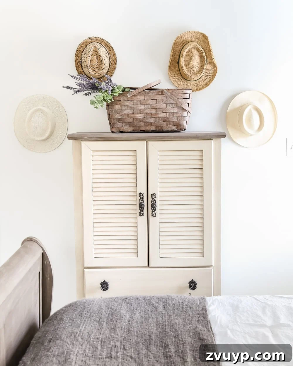 The newly organized corner with the armoire, hats, and refreshed wall art.