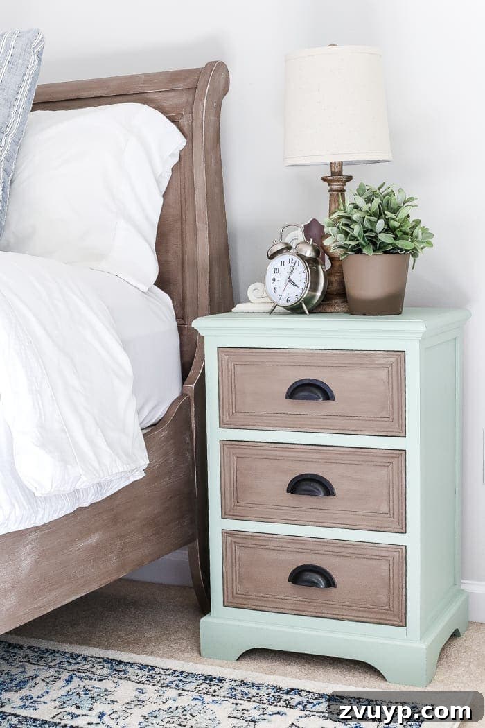The two-toned nightstands with bedside lamps and decor.