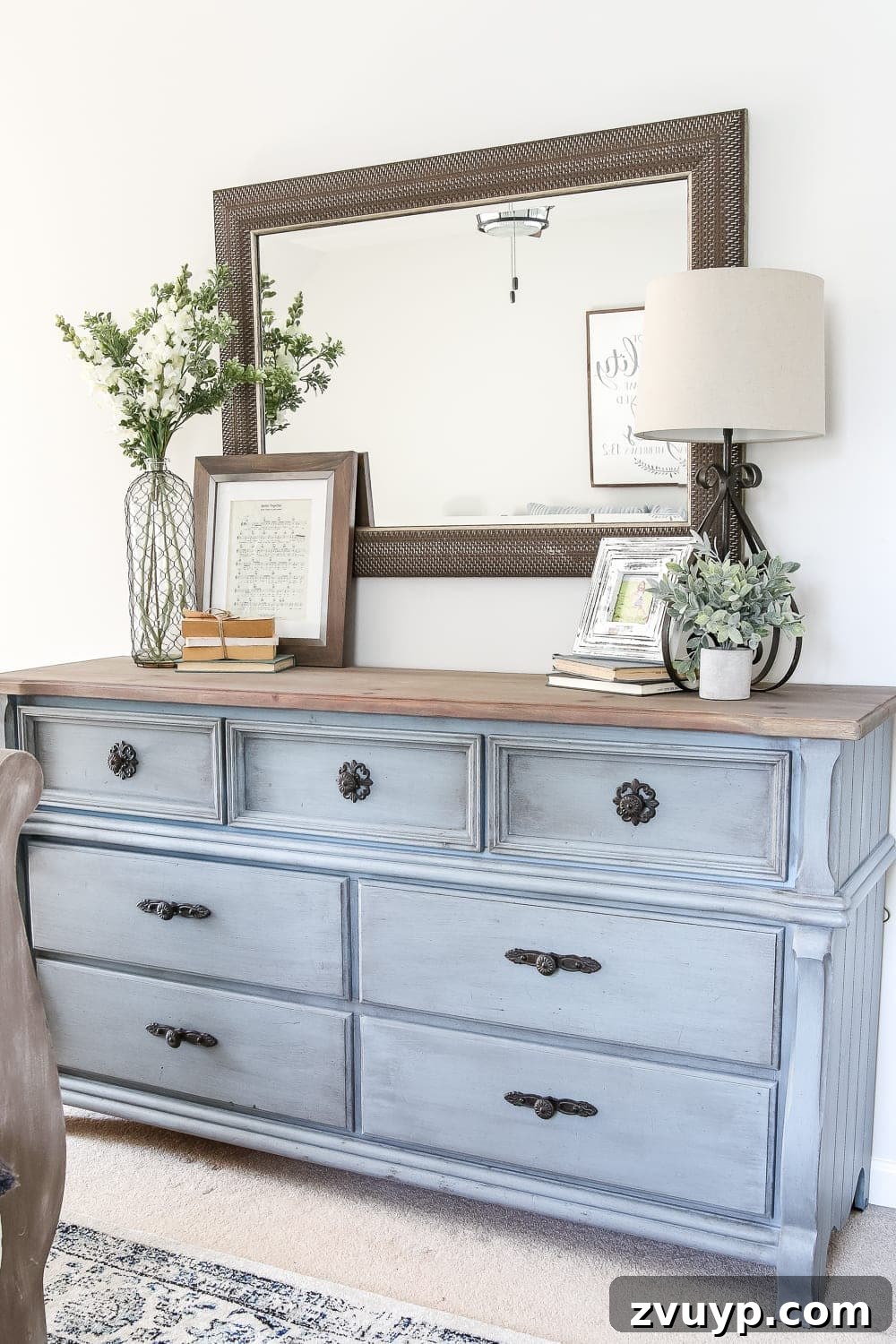 The French blue dresser, a highlight of the guest bedroom makeover, with thoughtful decor.