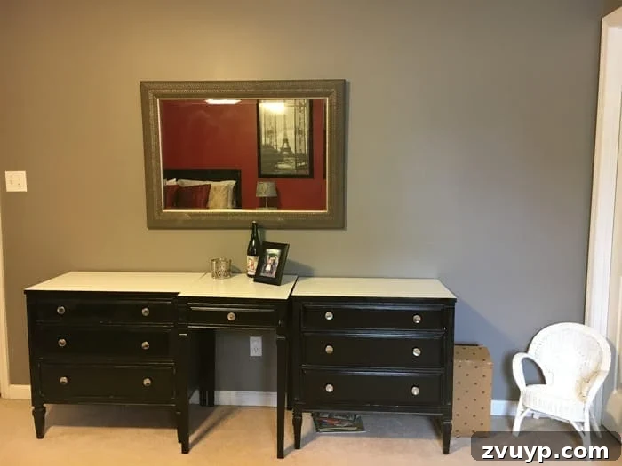 Before: Another view of the dated guest bedroom with heavy drapes and dark wood furniture.
