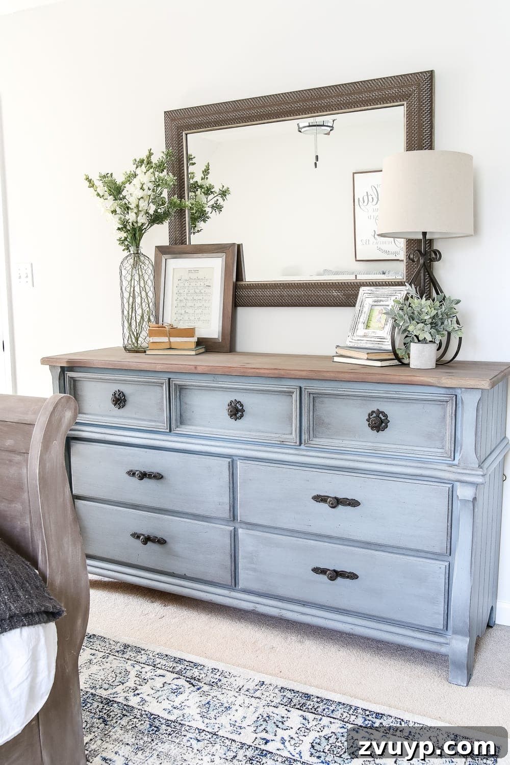 After: Side view of the renovated guest bedroom showcasing the refreshed nightstand and wall art.