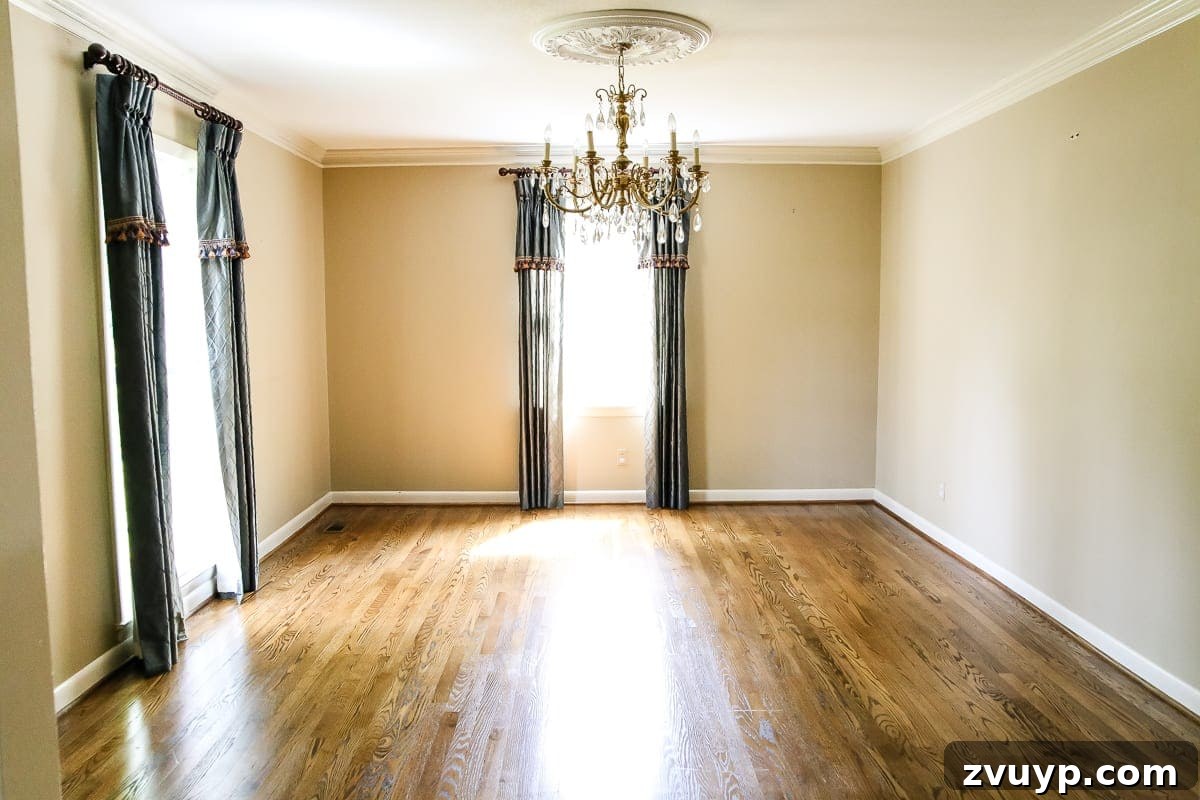Our New Home: The Unfurnished Tour 18 Home office space with a chandelier, large window, and light-colored walls, ready for personalized design updates.