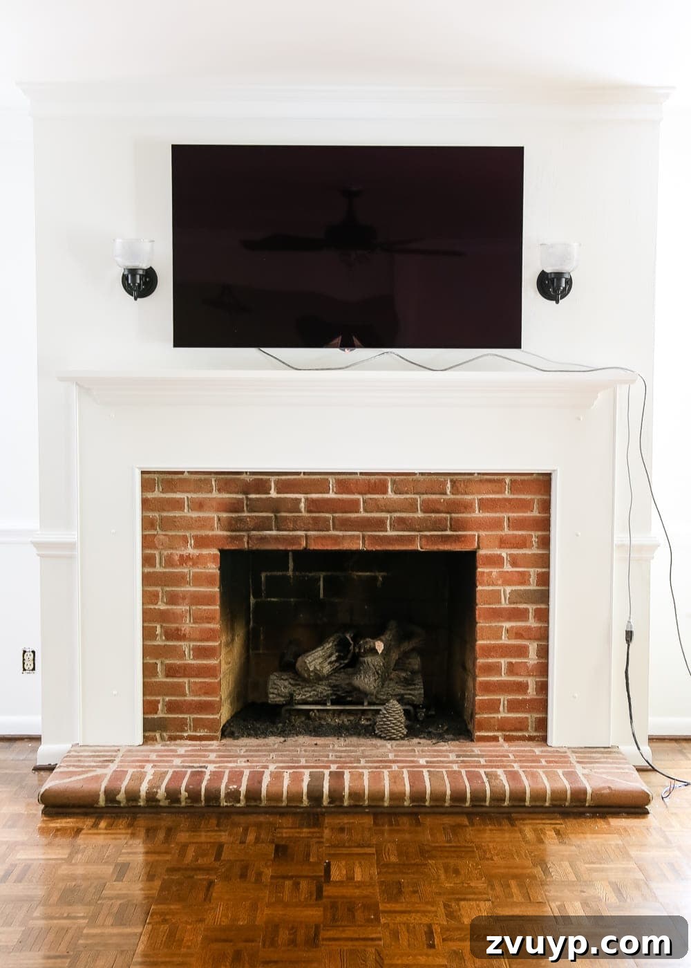 Dramatic Contrasts Living Room Paint Update 8 Fireplace with a television mounted above and a glimpse of the new paint colors