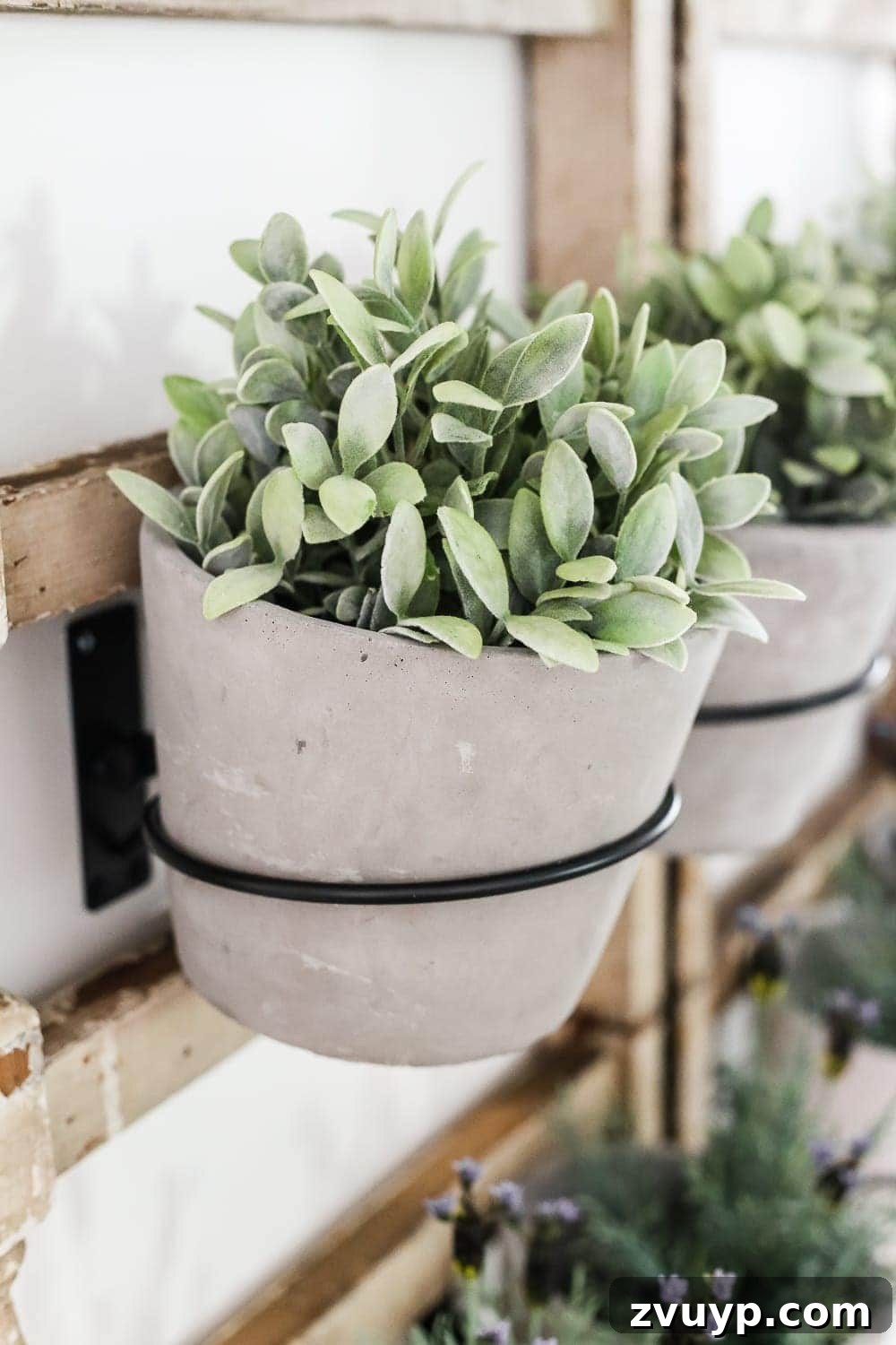 Heirloom Railing Wall Garden 5 DIY Antique Banister Wall Planter | www.blesserhouse.com - A quick and simple tutorial for how to make a wall planter from a repurposed antique banister using artificial plants. Cute way to bring the outdoors in!