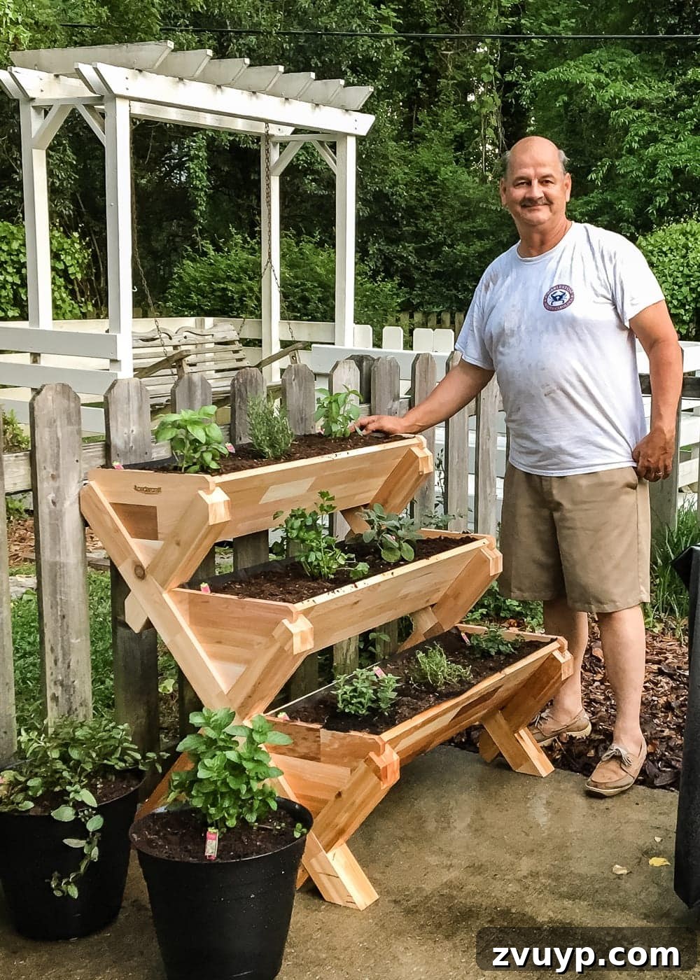 Whimsical Wooden Spoon Garden Labels 7 DIY Wooden Spoon Garden Markers | Showcasing the growth of herbs in a stacked garden alongside handmade wooden spoon markers. A testament to gardening success for beginners.