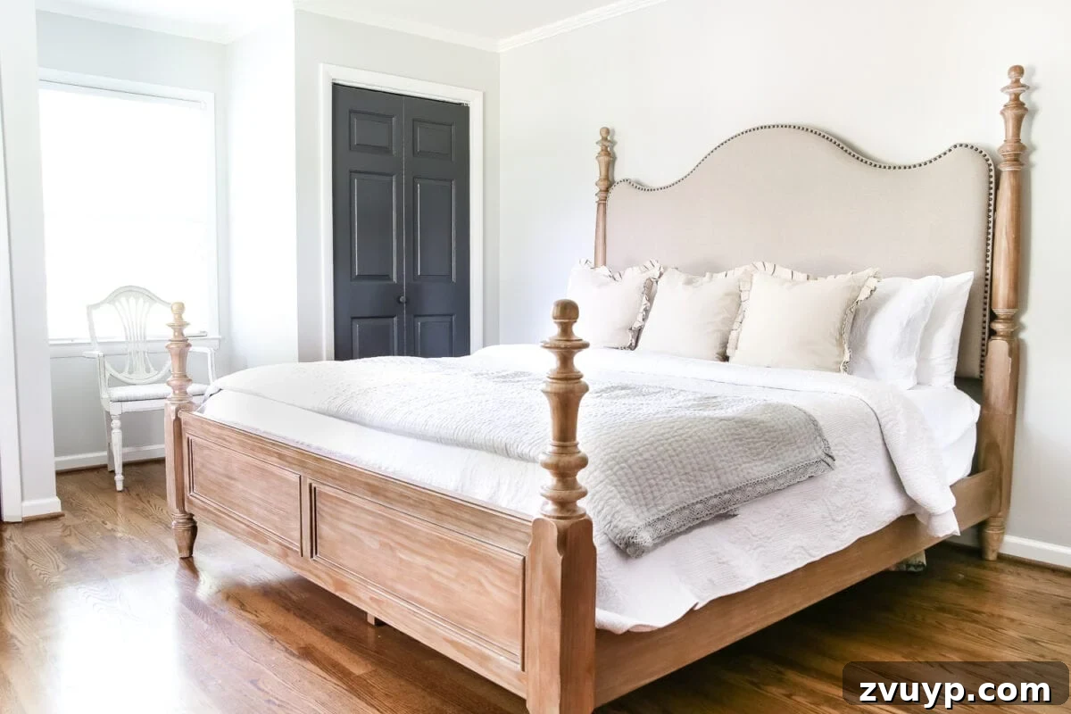 Pickled Pine Perfection for Your Master Retreat 3 Elegant pickled pine bedroom set, including a stylish bed with an upholstered headboard and nailhead trim, and a matching chest of drawers, enhancing a rustic-modern bedroom design.
