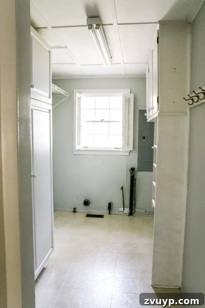 Charming Laundry Day Decor Printables 3 Original look of the laundry room before makeover, showing a basic and unstyled space.