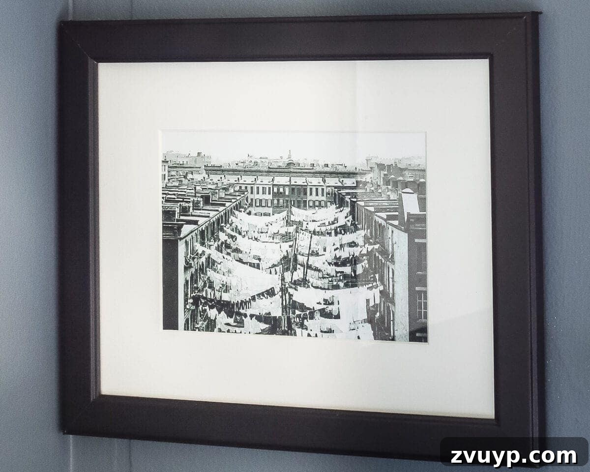 Charming Laundry Day Decor Printables 8 Detailed vintage clothesline art print, showcasing a nostalgic cityscape scene with drying laundry.